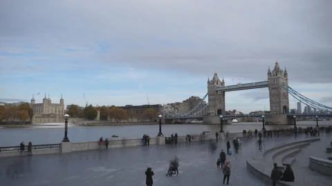 Busy people walking on the river side of the Thames River. Autumn in a city. Stock Footage 119668237