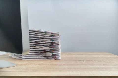 Busy pile overload document report and computer on wooden table Stock Photos