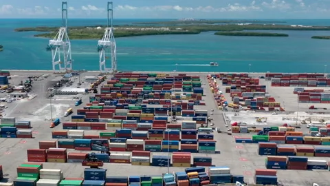 Busy port time-lapse. Loaded trucks and colorful containers in shipping dock 4K Stock Footage