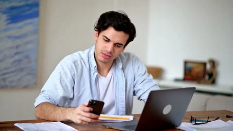 Busy positive hispanic stylish young man, student or freelancer, sitting at work Stock Footage 163024482