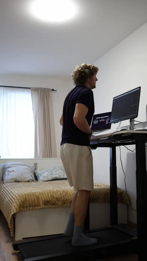 Busy remote worker needs the bathroom but continues working through discomfort Stock Footage 346881265
