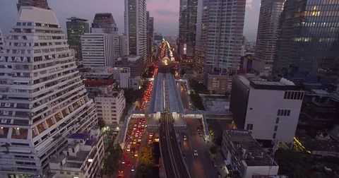 Busy Road and Skytrain in Central Bangkok at Dusk, Aerial Approach Shot Video stock 78598666