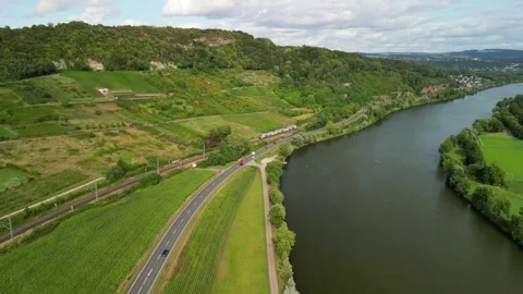 Busy road and train next to Moselle river Stock Footage 247273341