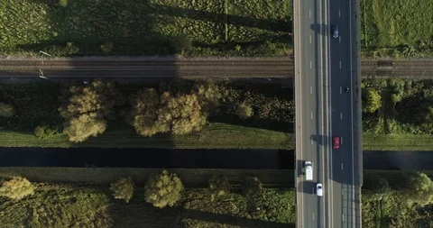 Busy road with train track and canal in English countryside Stock Footage 102411361