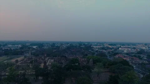 A busy road with vehicles separating a temple and a city Stock Footage 111595829
