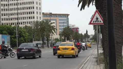 Busy rush hour traffic drives through streets of Tunis city Tunisia Stock Footage 345035201