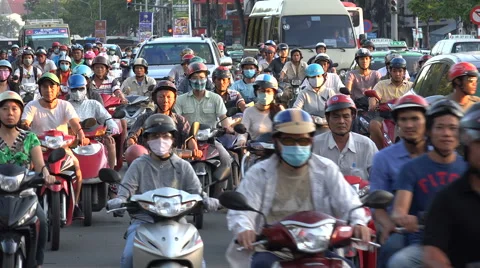 Busy rush hour traffic, people on motorbikes commute, Saigon, Vietnam, Asia Stock Footage