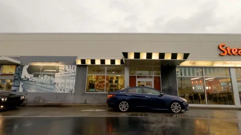Busy Steak N Shake drive thru on a rainy and cloudy day in Georgia Stock Footage 147209024