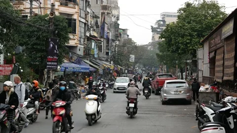 People Crossing Street In The Busy Streets Of Hanoi, Vietnam Stock