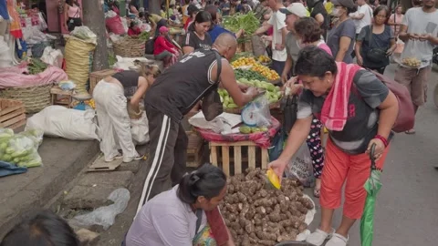 A busy street market with an array of fresh vegetables being sold. Stock Footage 285999808