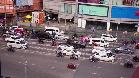 Busy street rush hour in front of mall, driving the same direction, Bangkok Stock Footage 314764680