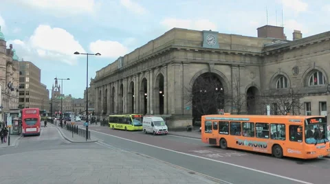 Busy street scene with buses outside Newcastle Central Station Stock Footage