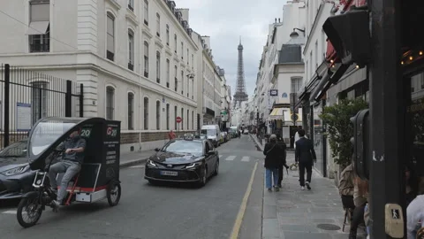 Busy streets of central Paris with the view of the Eiffel Tower in the distance. Stock Footage 278920023
