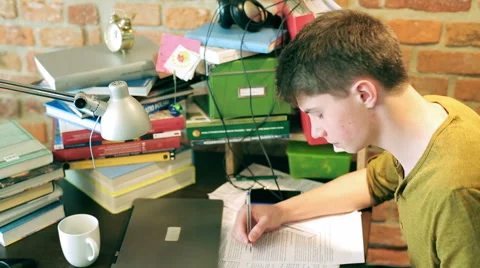 Busy student studying and writing notes  Stockbeeldmateriaal 40928448