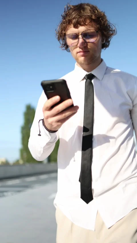 Busy supervisor checks work chats and messages on smartphone while walking Stock Footage 345993379