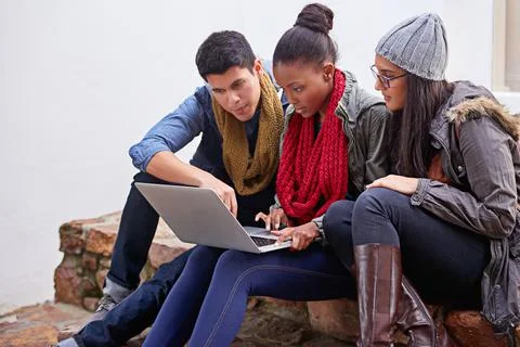 Busy with their latest homework assignment. Shot of a group of university Stock Photos