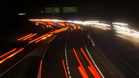 Busy time lapse traffic at night.  Light streaks through the darkness Video stock 99583959