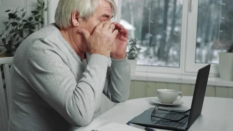 Busy Tired Old Man Using Laptop working from home. Stressed Older Man Stock Footage 234406964
