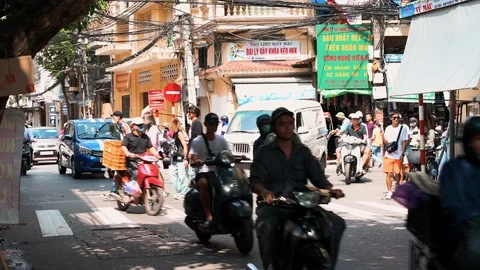 Busy traffic down narrow roads in old quarter, Hanoi - Capital of Vietnam Stock Footage 119021076
