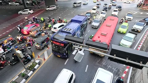 Busy Traffic Jam with Buses and Motorcycles at Bangkok City Intersection 動画素材 327186386