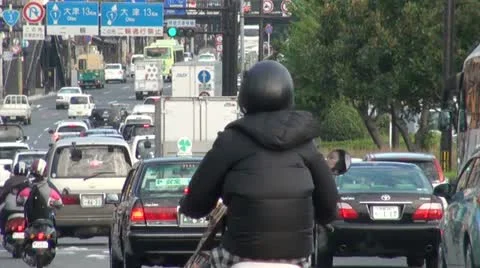 Busy traffic lane in Japan motorbike cars bus rush hour city Japanese Stock Footage