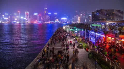Busy traffic of people walking by the seaside in Tsim Sha Tsui in Hong Kong Stock Footage