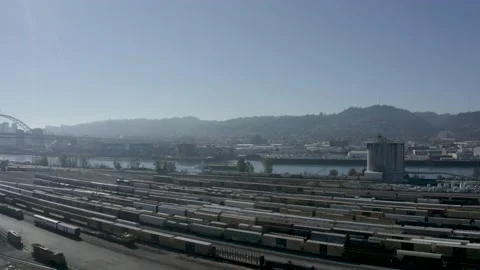 Busy Train Yard as a Cargo Ship Passes by Stock Footage 146319583