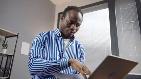 Busy, typing and a black man with a laptop at work for communication Stock Footage 264511547