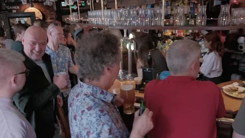 Busy UK pub setting, drinking alcohol, pulling pints, people. Hull.UK.6.7.2024 Stock Footage 280462759
