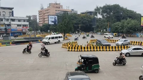 Busy urban intersection with auto rickshaws, cars, motorcycles and pedestrians m Stock Footage 345185319