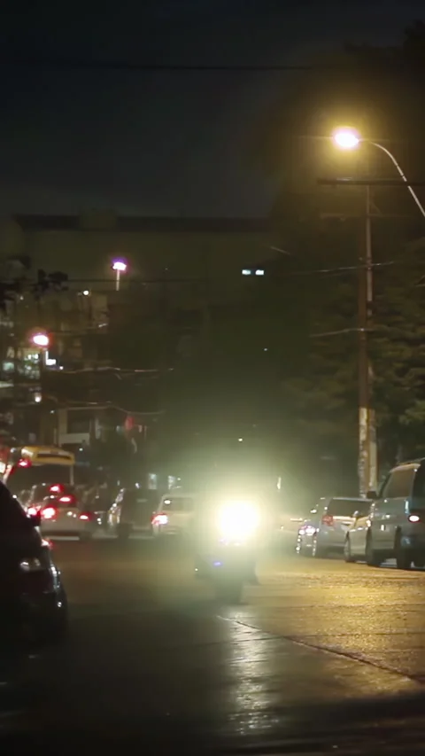 Busy Urban Intersection at Night with Fast Moving Traffic in Paraguay - Vertical Stock-Footage 332877797