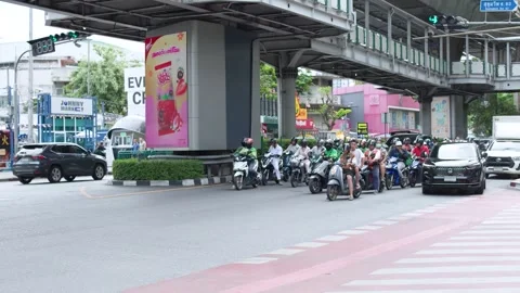 Busy Urban Traffic Intersection with Motorcyclists and Commuters in Bangkok Stock Footage 340183146