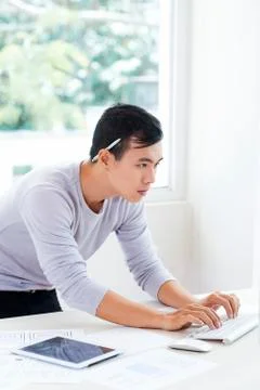 Busy Vietnamese IT engineer coding information Stock-Fotos