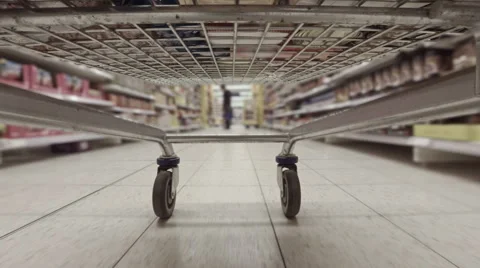 Busy view from underside of shopping trolley weaving between aisles in superm Vídeo Stock 58347556