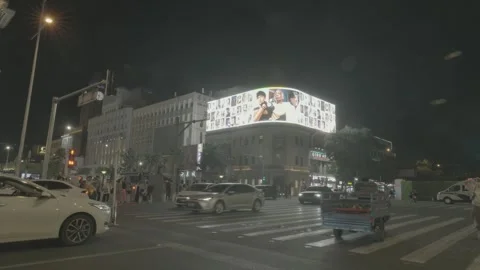 Busy Wangfujing Intersection Under Giant LED Billboard at Night Stock Footage 340480541
