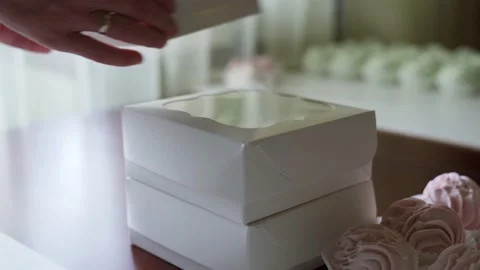 Busy woman make a stack of white boxes with handmade marshmallows for a buyers. Stock Footage 216732309