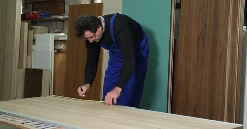 Busy Woodworker Man Working Using Tape Measure in Carpentry Workshop Activity Stock Footage 83433918