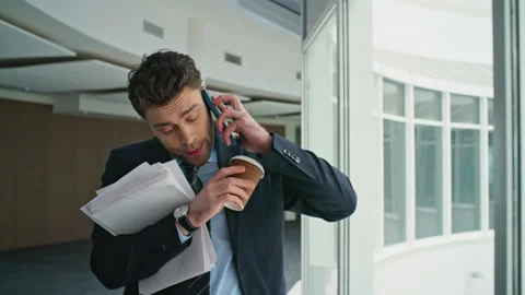 Busy worker answer cellphone call hurrying on office work closeup. Man talking Stock Footage 280493106