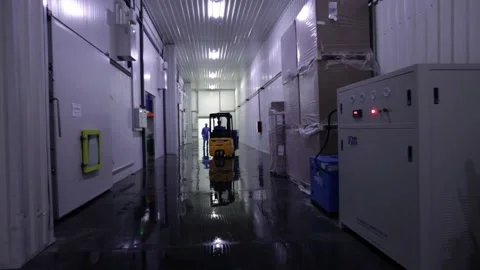 Busy Worker In a Factory Using A Forklift Truck To Move Boxes Stock Footage 153027877