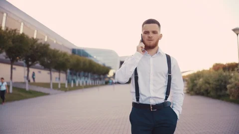 Busy young bearded ginger man in formal outfit walking down the street and Stock Footage 115669072