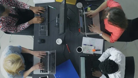 Busy young professionals communicating and analyzing the data Stockbeeldmateriaal 73848333