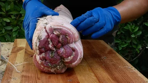Butcher binds meat rolled up for pochette roast pork Video stock 242080522