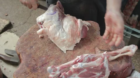 Butcher chopping bones of mutton leg with axe Stock-Footage 8368002