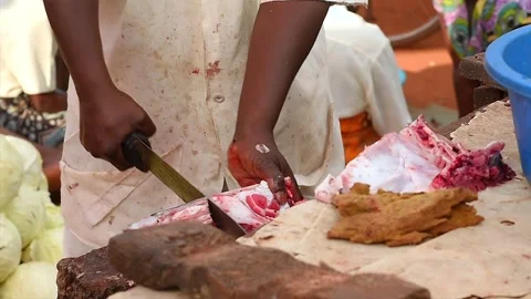Butcher chopping fresh meat in Uganda street market Stock-Footage 297537053