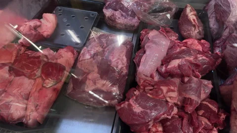 Butcher Counter with Assorted Raw Red Meat Cuts and Offal Stock Footage 337911271