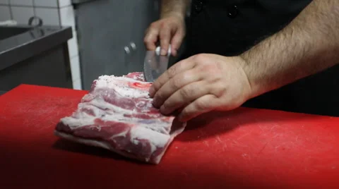 Butcher cut up the meat with a knife Stock Footage 44230830