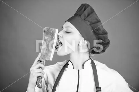 Butcher cut meat. professional chef in kitchen. Cuisine. woman in cook hat and Stock-Fotos