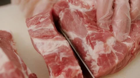 The butcher cuts the meat Stock Footage 158741028