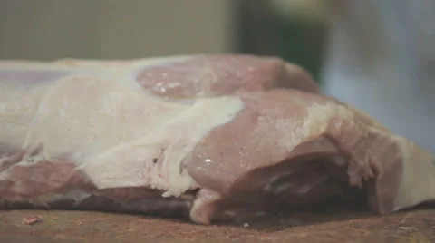 A butcher cuts pork carcass into portion pieces with an axe closeup Stock Footage 63997455