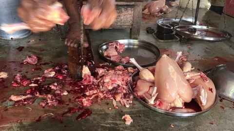 A butcher is cutting chicken Stock Footage 100867112